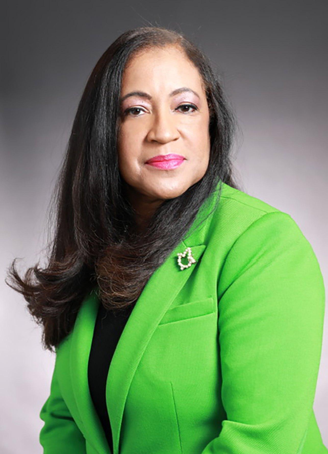 Professional portrait of Dr. Carolyn Haliburton Carter in a green blazer.